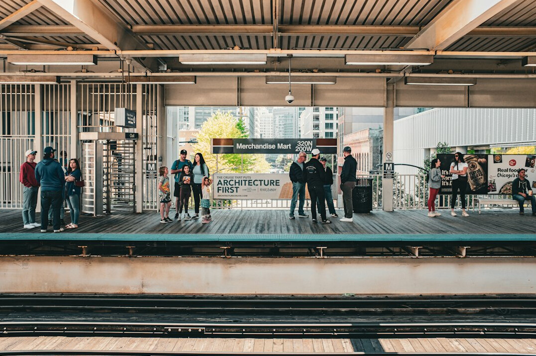 Commuters waiting on a train station platform