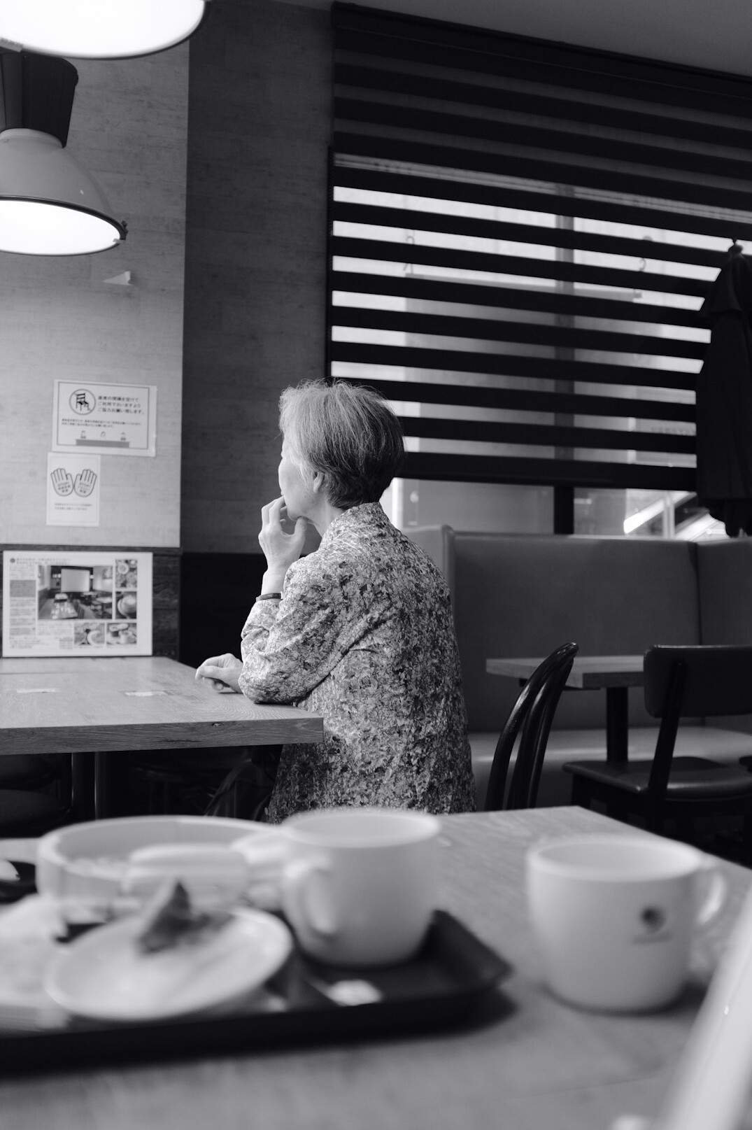 elderly woman sharing story at table